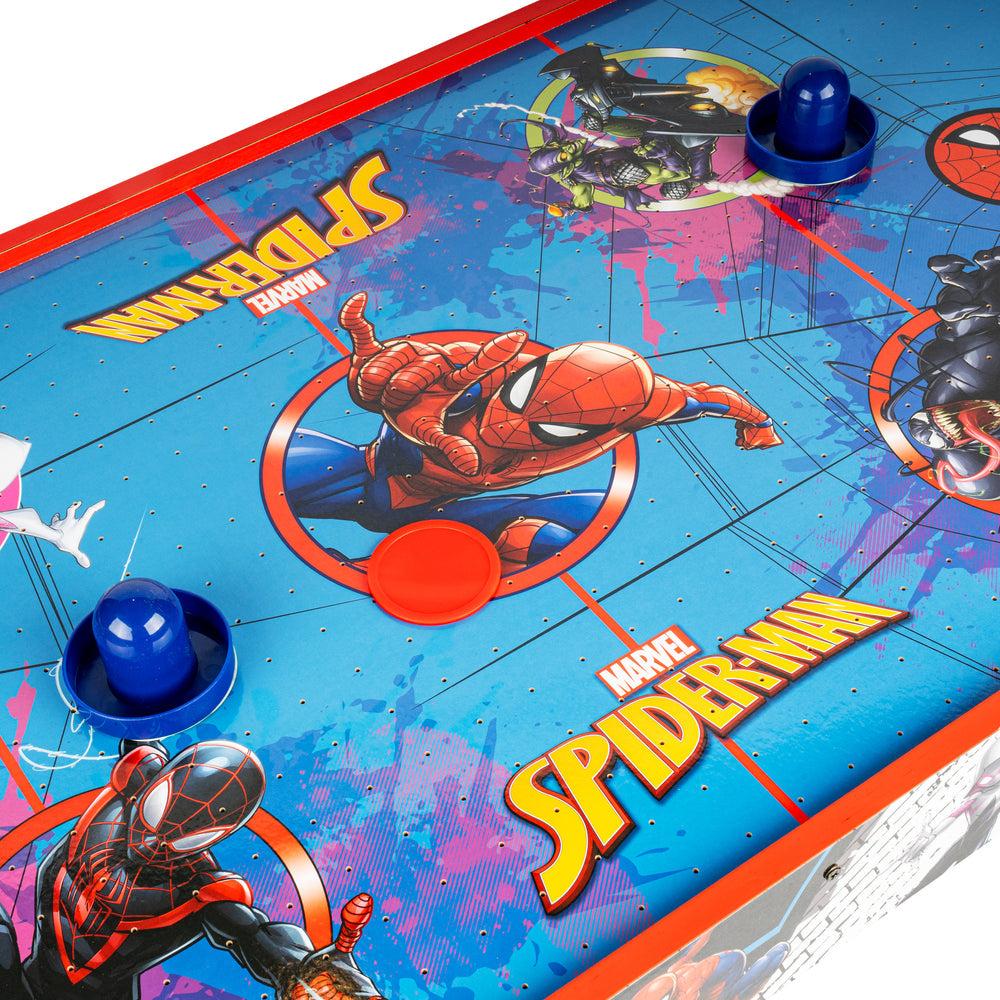 Marvel Spider-Man air hockey table featuring colorful Spider-Man graphics, blue pucks, and red and blue player discs on a bright blue playing surface.