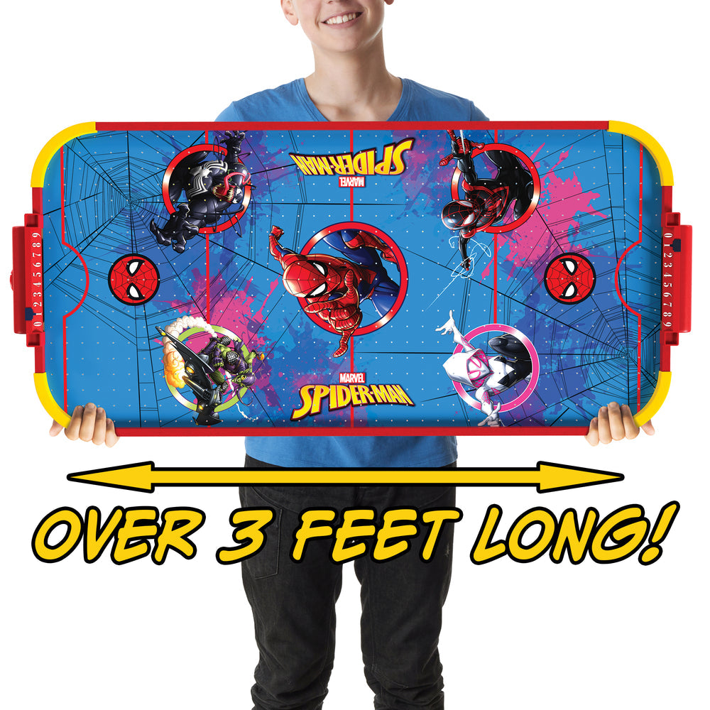 A person holding a large Marvel Spider-Man themed air hockey table against a white background, with text overlay reading 'OVER 3 FEET LONG!'.