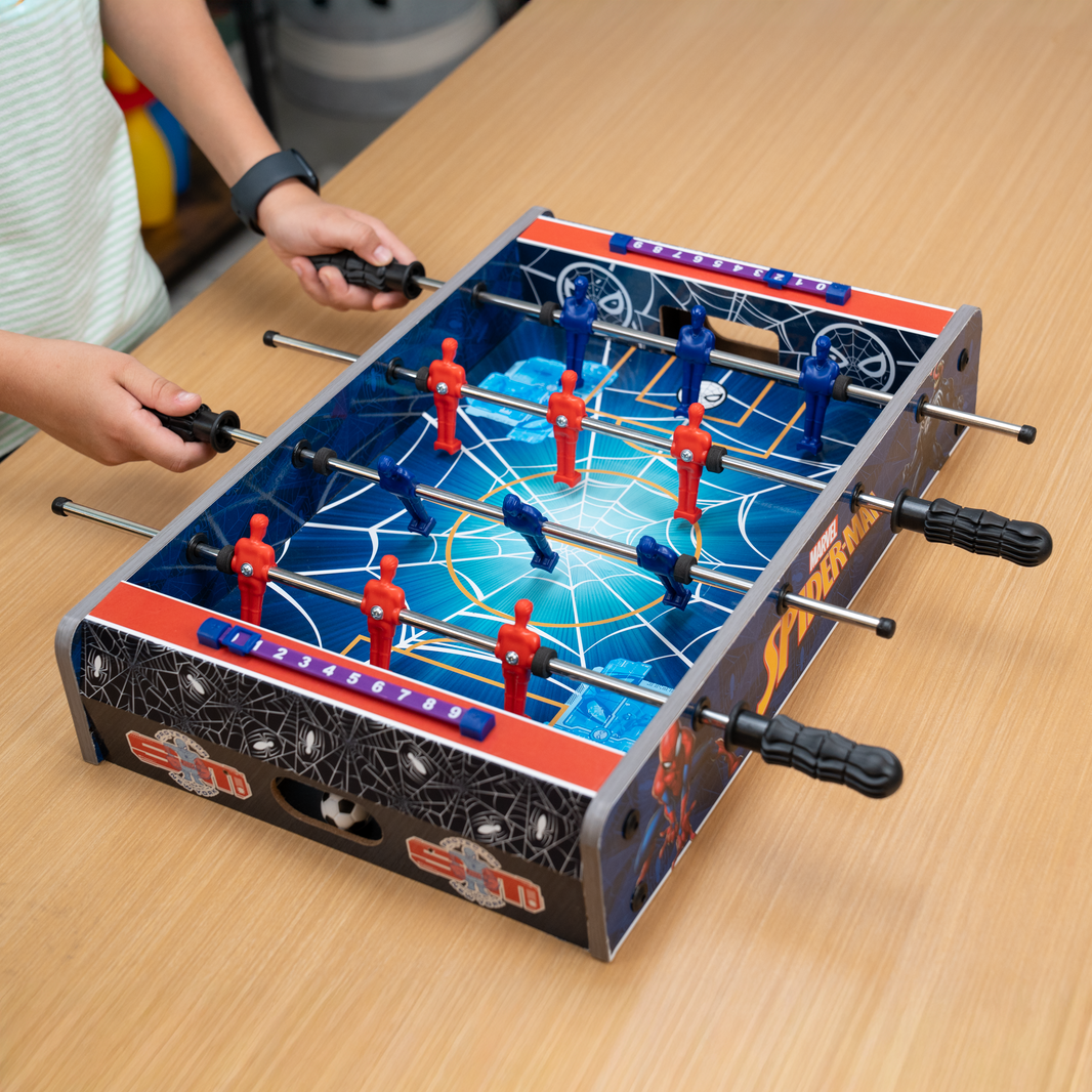 Tabletop foosball game with players on a wooden table