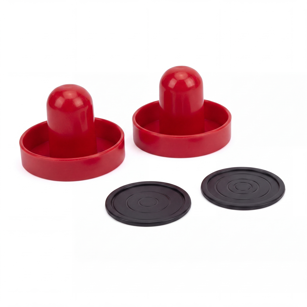 Two red plastic game pieces with rounded domes and circular bases, shown alongside two black circular discs on a plain white background.