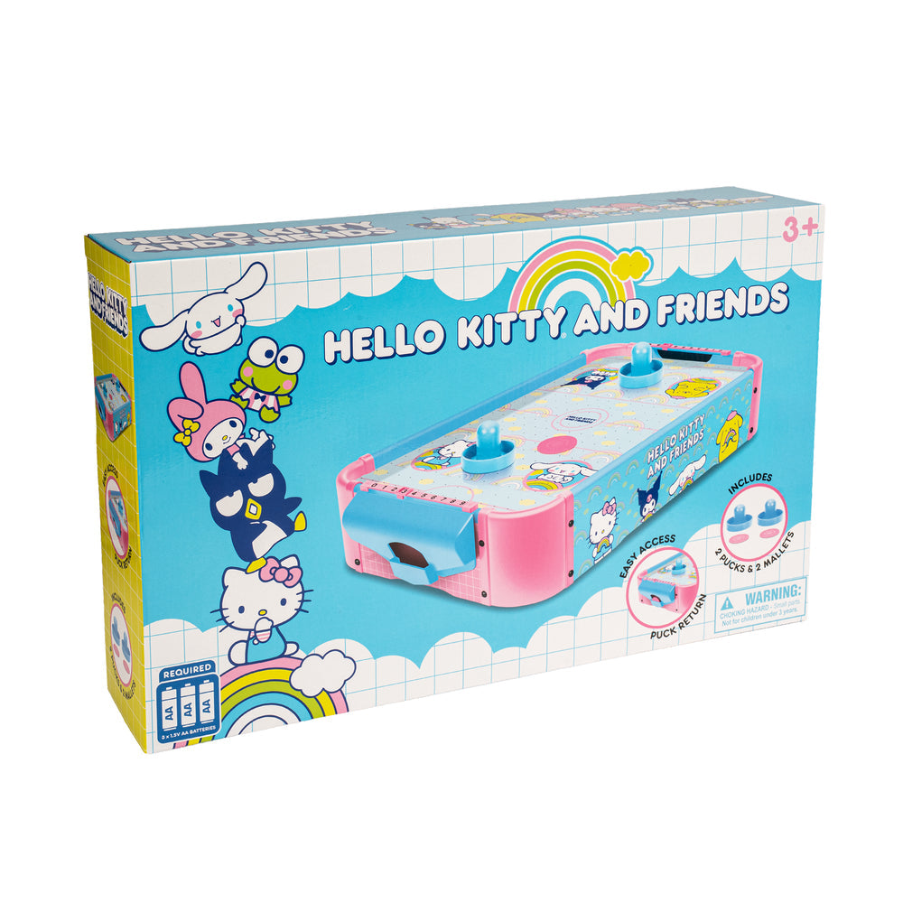 Hello Kitty and Friends table tennis toy packaging box, featuring Sanrio characters like Hello Kitty, My Melody, and Cinnamoroll on a light blue background with a rainbow graphic.