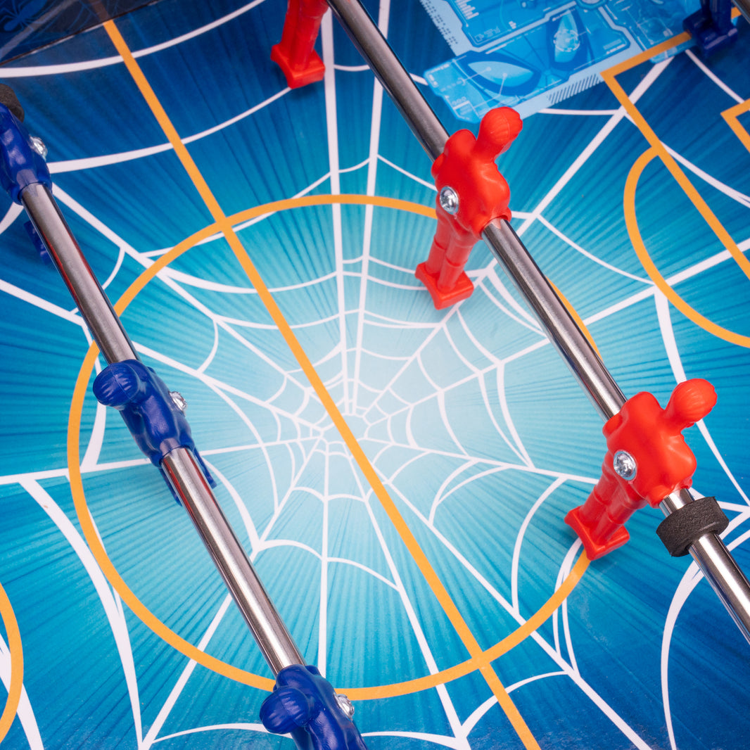 Close-up of a toy spider web with red and blue spider figures on a blue background