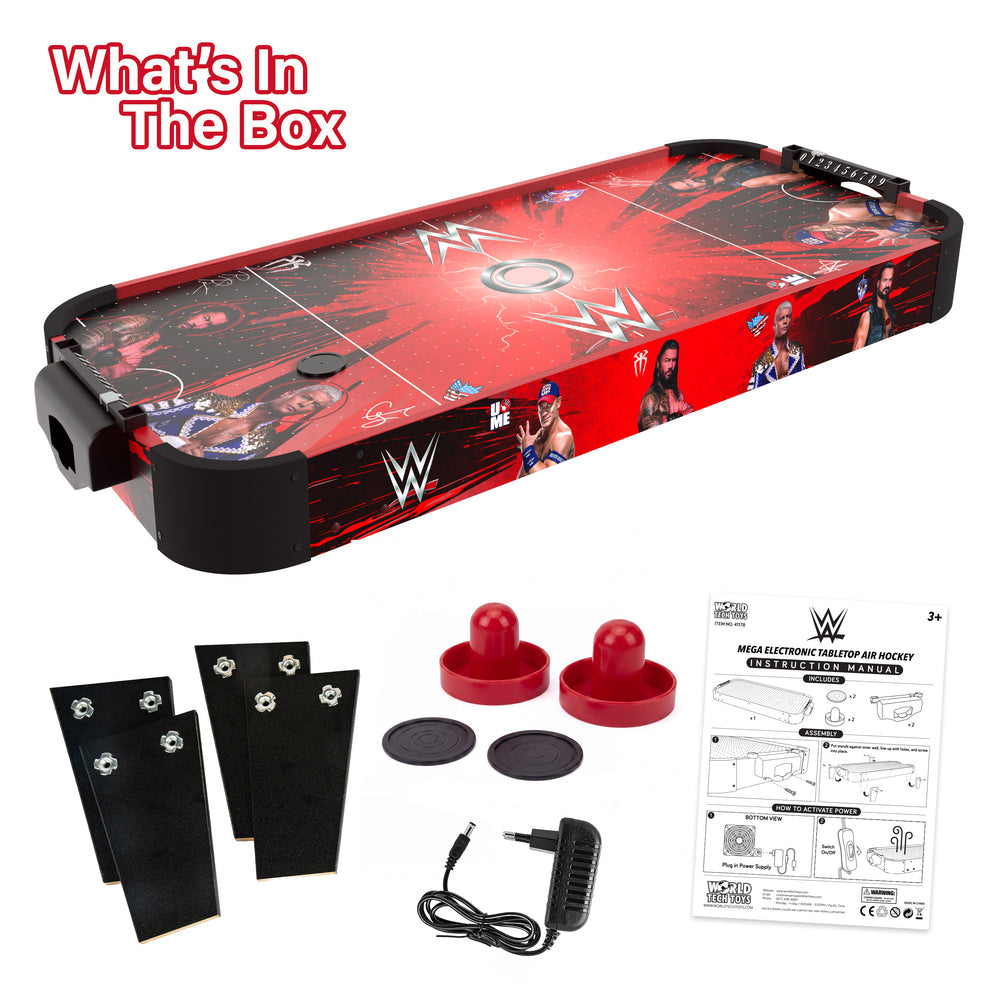 WWE air hockey table set with red and black graphics, shown with accessories including black mounting brackets, red puck bumpers, circular discs, a power adapter, and an instruction manual on a white background.