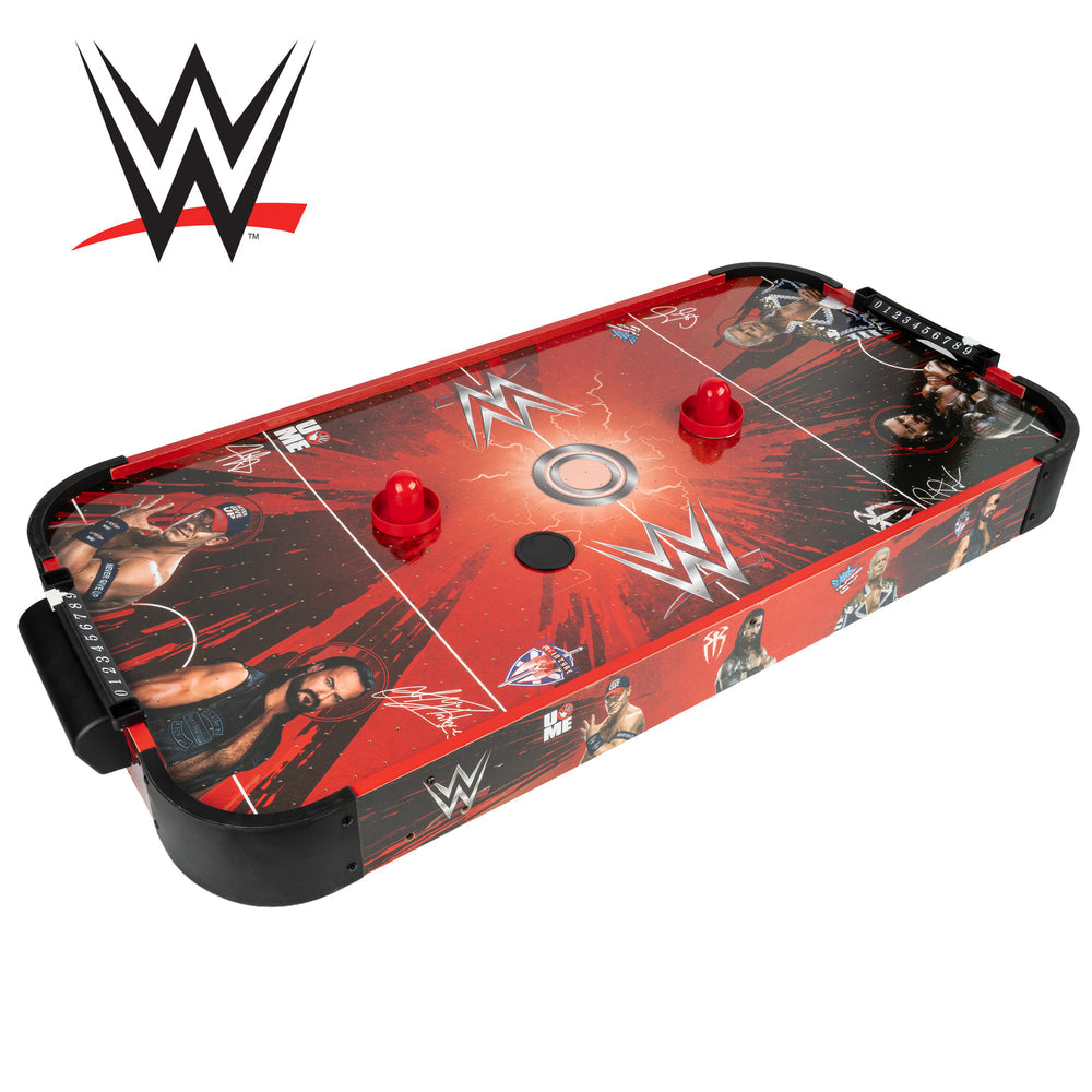 WWE-themed air hockey table featuring red and black graphics with wrestler illustrations and logos, shown on a white background with a WWE logo in the top-left corner.